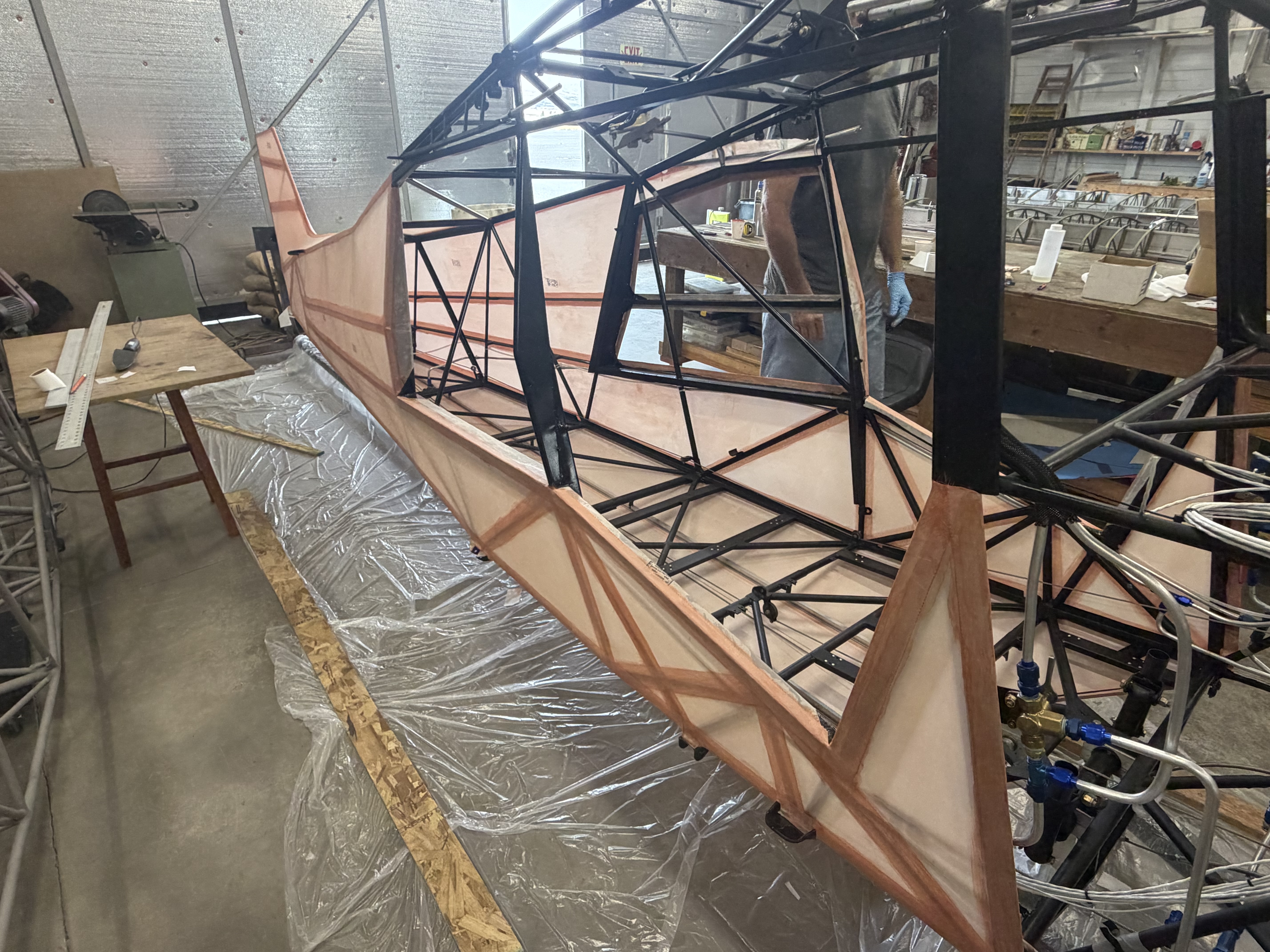 Experimental Super Pacer fuselage — rear quarter view with builder in the shop